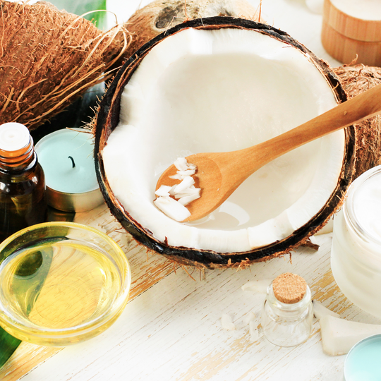 Fresh coconut half with organic coconut oil in a bowl - Nourishing and natural skincare with coconut goodness.