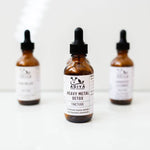 Three bottles of Adiya Heavy Metal Detox Tincture on a white background