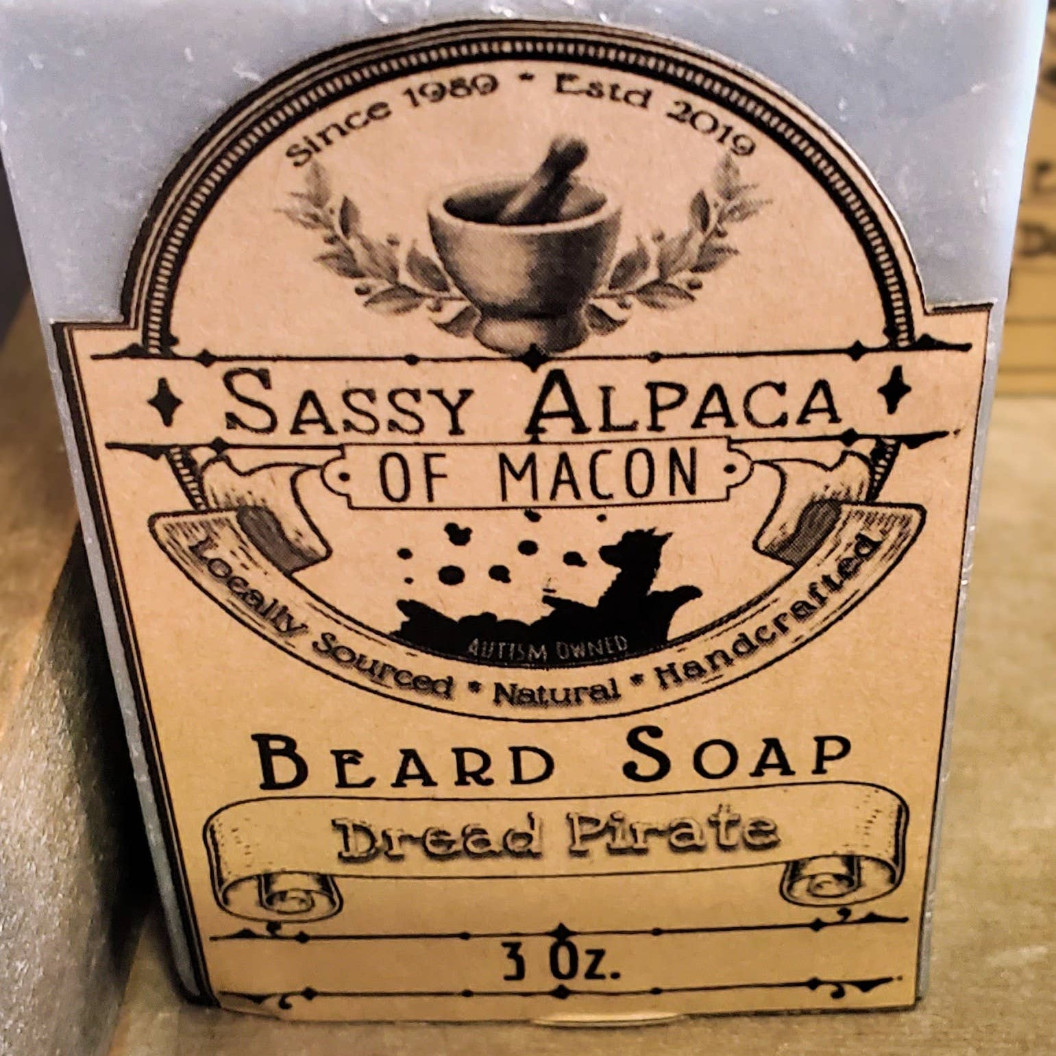 Beard soap with a label on a wooden surface