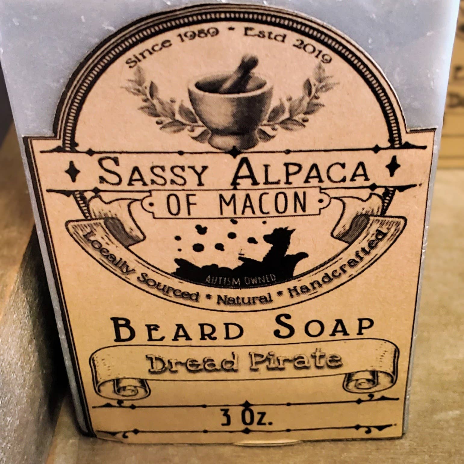Beard soap with a label on a wooden surface