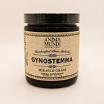 Anima Mundi dark jar on cream background with "gynostemma" on tan label