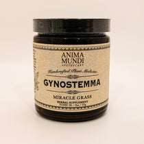 Anima Mundi dark jar on cream background with "gynostemma" on tan label