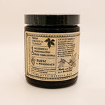 Jar of herbal product with a detailed label on a beige background