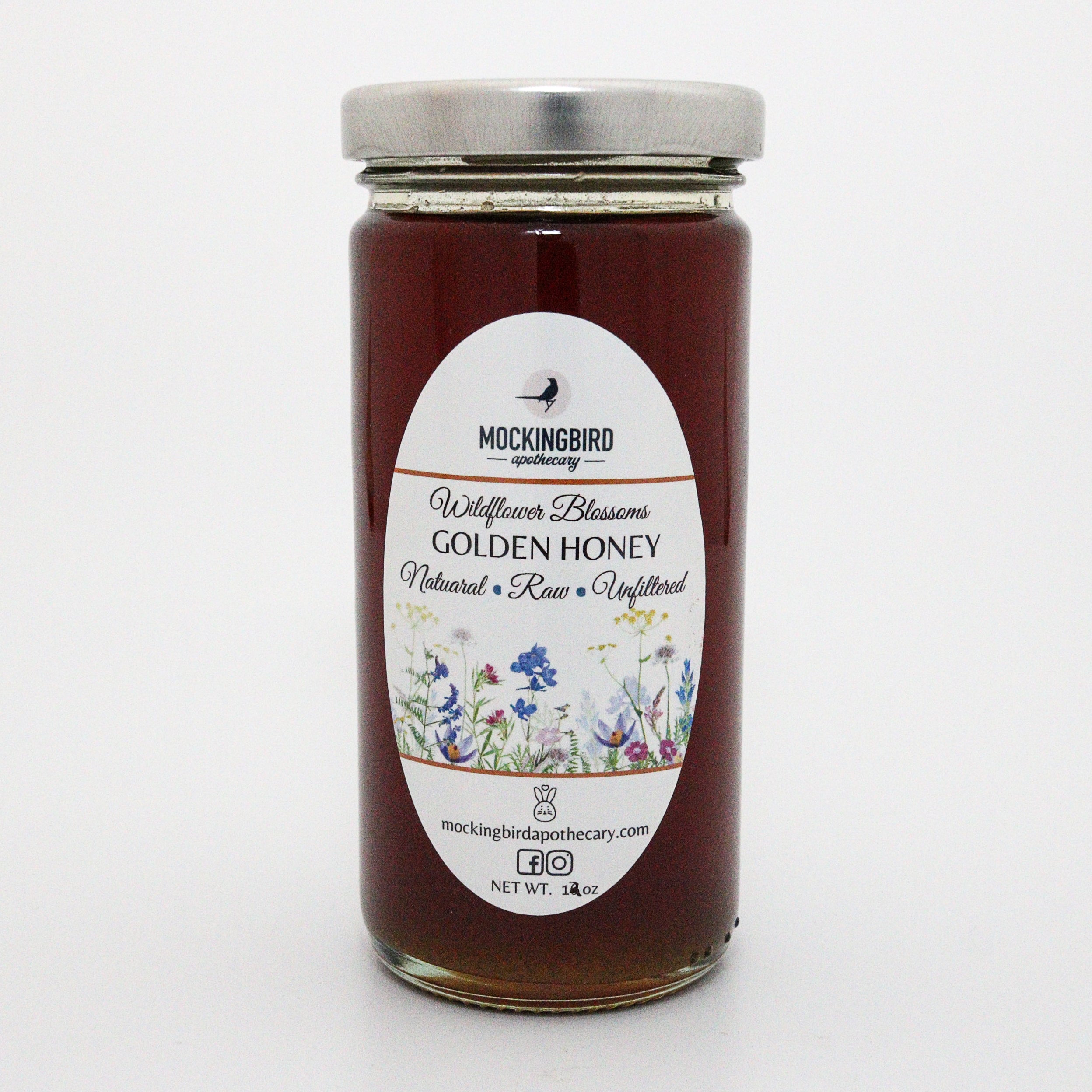 Jar of Mockingbird Apothecary Wildflower Blossoms Golden Honey on a white background