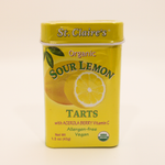 Yellow tin canister of St. Claire's Organic Sour Lemon Tarts on a white background
