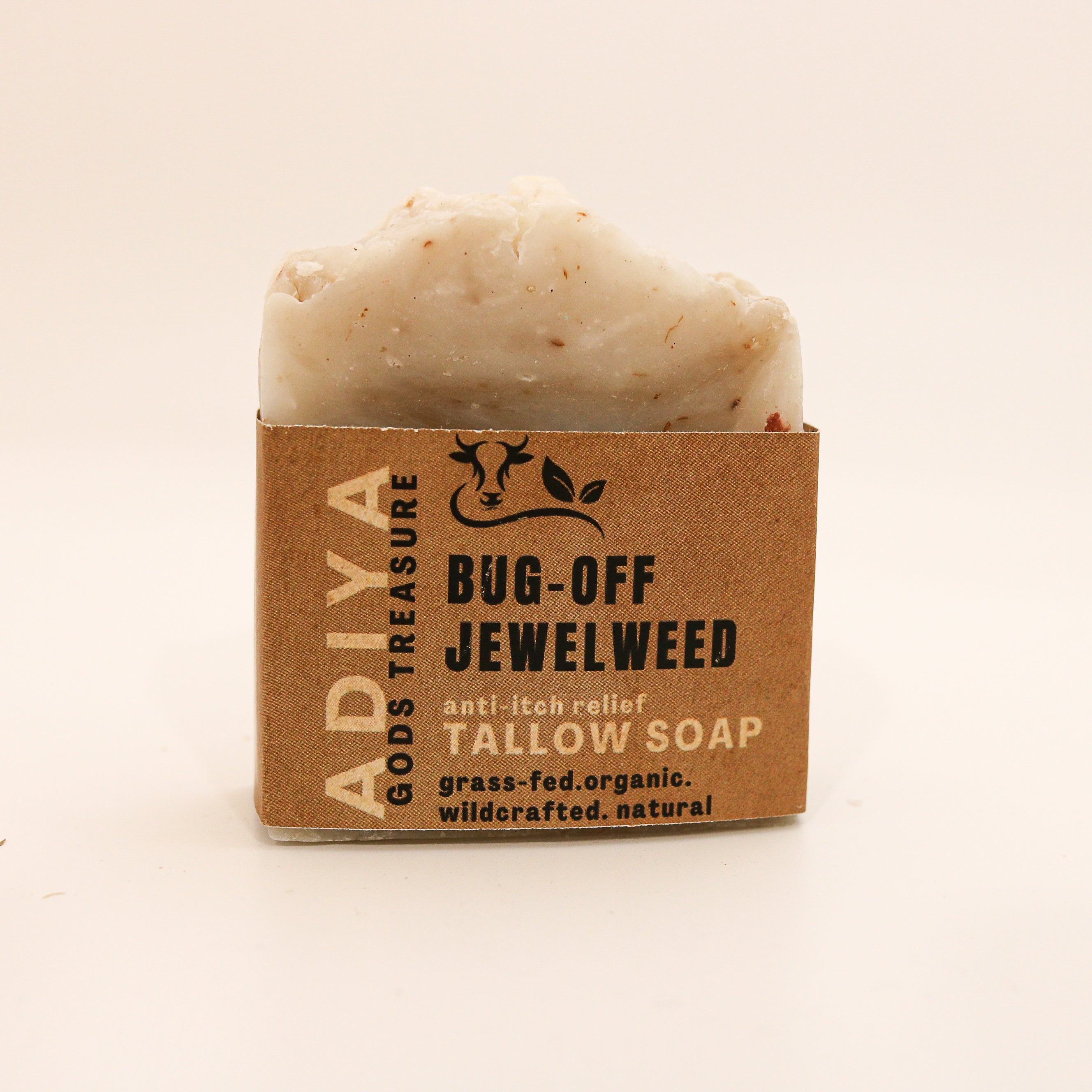 Bar of bug-off tallow soap with a brown cardboard packaging on a beige background