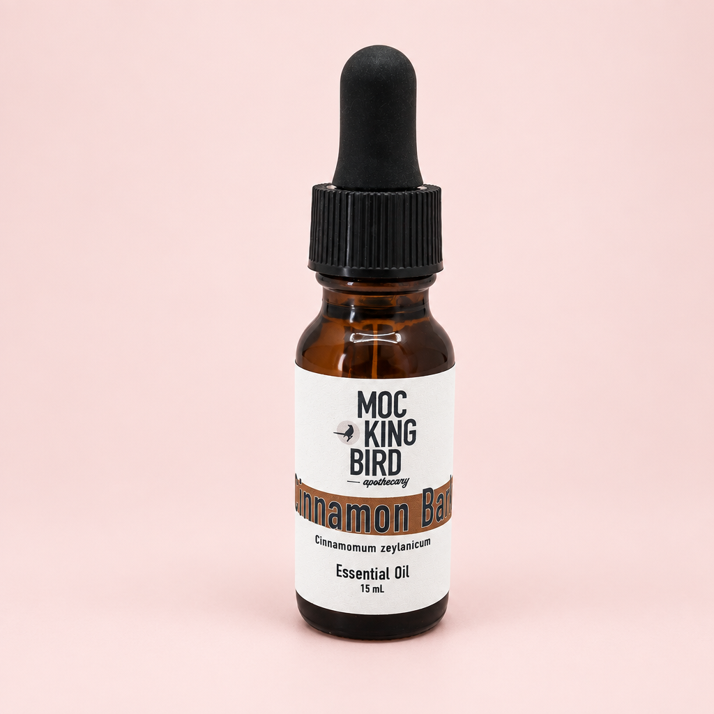 Mockingbird Apothecary Cinnamon Bark essential oil in a 15 mL amber glass bottle with a black dropper cap on a white background.