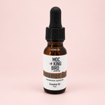 Mockingbird Apothecary Cinnamon Bark essential oil in a 15 mL amber glass bottle with a black dropper cap on a white background.