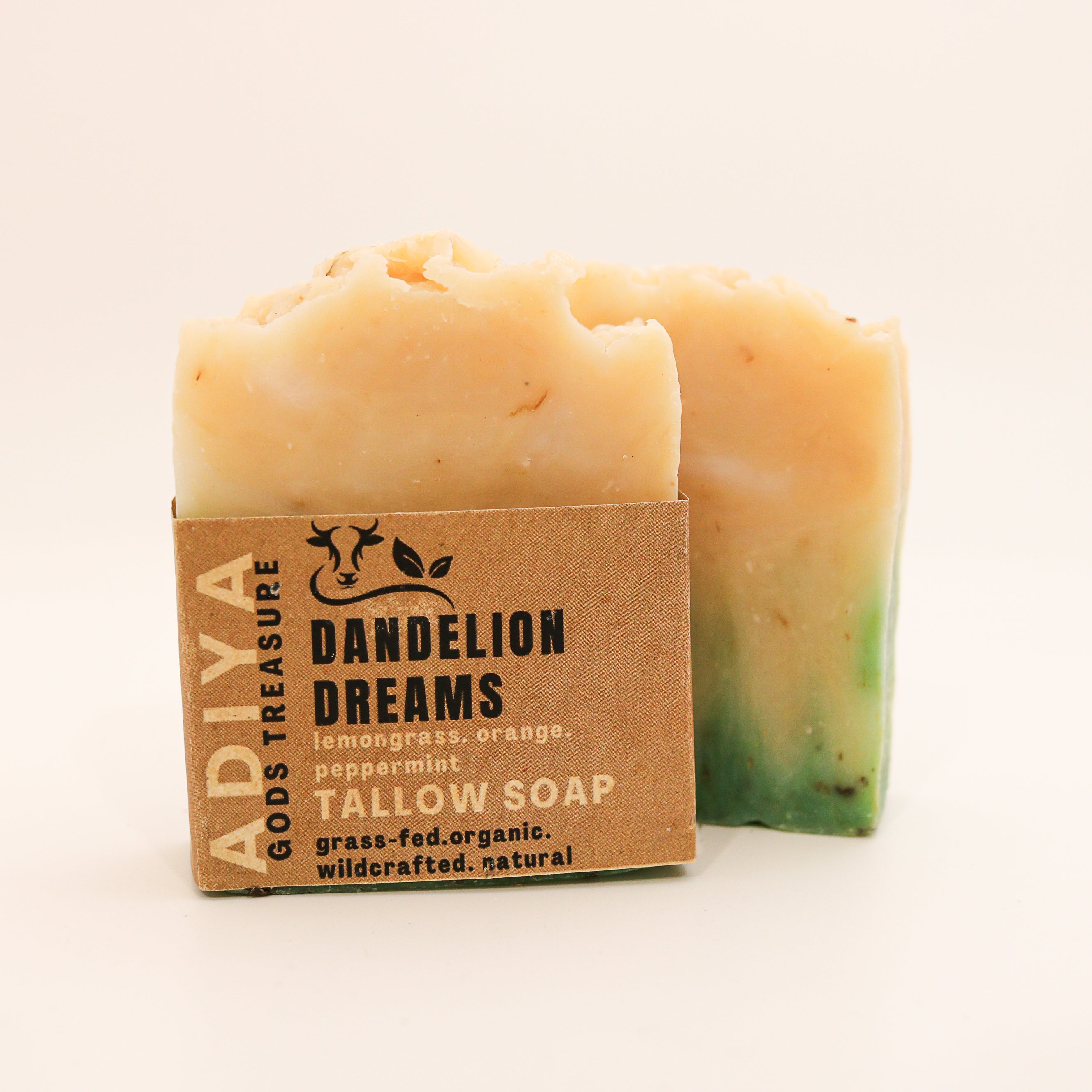 Bar of soap with a cardboard packaging labeled 'Dandelion Dreams' on a beige background