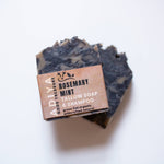 Two soap bars with a cardboard label on a white background