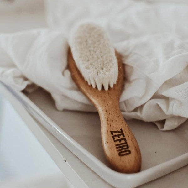 Wooden hairbrush with 'ZERRO' branding on a white surface