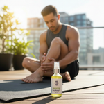 Post Workout Massage Oil lifestyle with man massaging calf after workout, clean skin, bright natural light