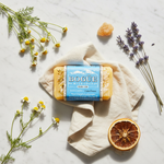 Bogüe Milk Soap No.34 Calm Down Wellness Blend – lifestyle flat lay with chamomile, lavender, bergamot and frankincense