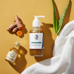 Aloe Turmeric ACV Natural Glow Cleanser flat lay on golden surface with turmeric root and aloe sprig