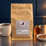 Phase Blend coffee in a midnight blue kitchen scene with a coffee cup, honey jar and almonds