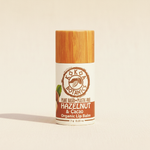 Hazelnut & Cacao Organic Lip Balm by Kokoa Botanics on soft natural linen background