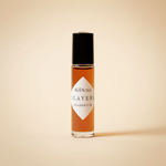 Adia Three Layers Fragrance Oil rollerball on pale warm amber background