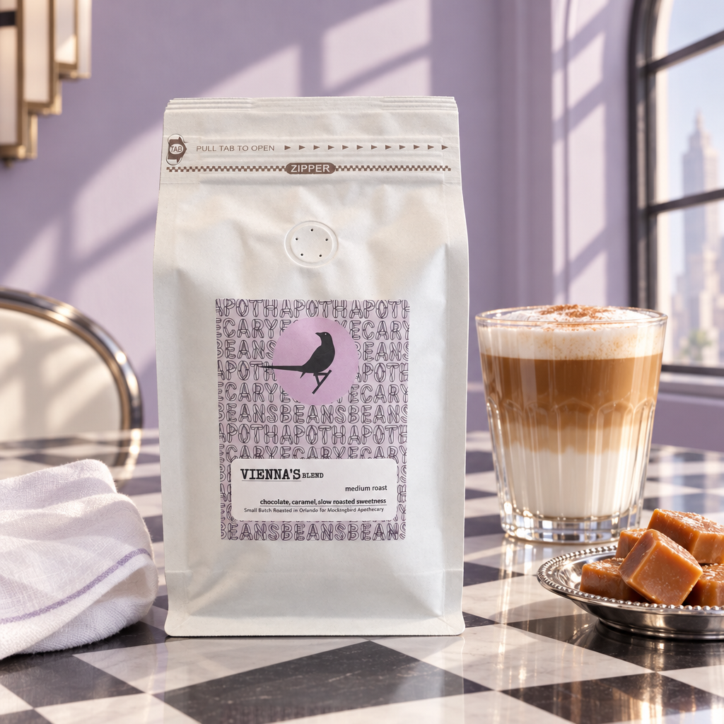 Vienna’s Blend coffee on a checkerboard table with a glass latte and lavender backdrop
