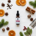Christmas Morning Essential Oil Blend – flat lay overhead on white linen with holiday botanicals