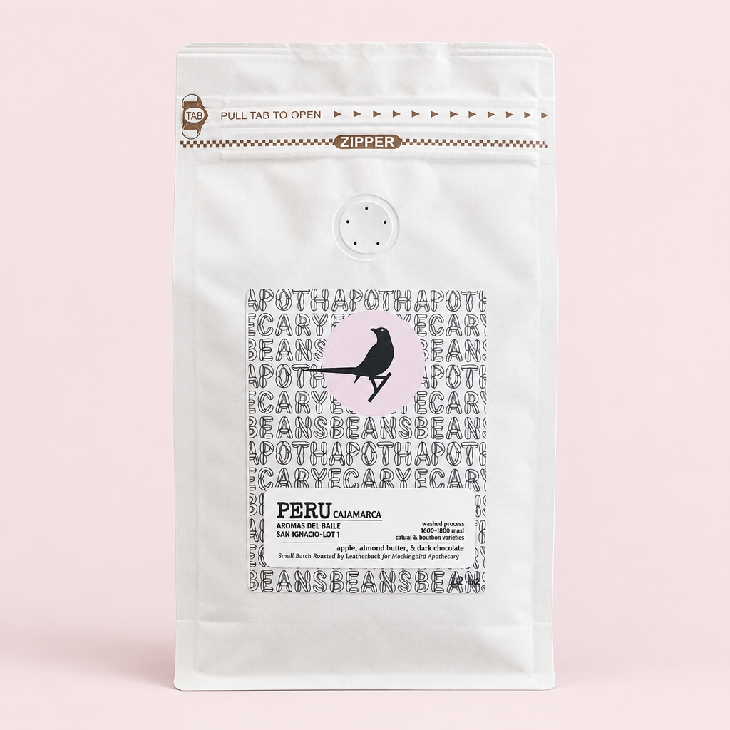 Peru Cajamarca coffee pouch on a pale pink background with a soft shadow