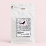 Peru Cajamarca coffee pouch on a pale pink background with a soft shadow
