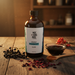 Mockingbird Apothecary Organic Elderberry Elixir styled with elderberry syrup bowl, raw honey, elderberry clusters, and rosehips on rustic wood