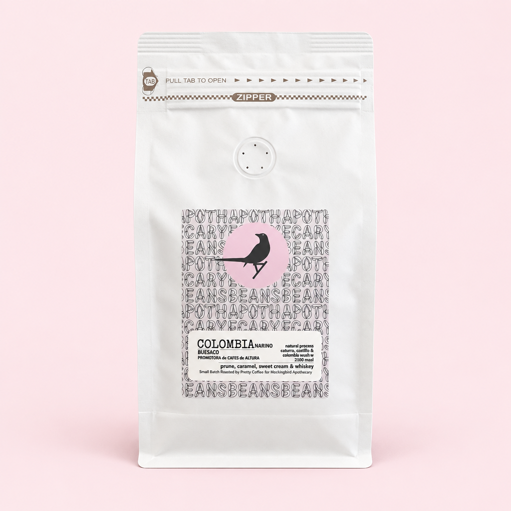 Colombia Nariño coffee pouch on a pale pink background with soft shadow