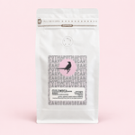 Colombia Nariño coffee pouch on a pale pink background with soft shadow