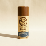 Blue Oil Calming Body Butter Stick by Kokoa Botanics on warm cream linen background