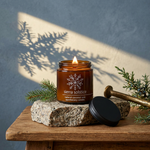 Sierra Solstice amber candle on a granite plinth with evergreen accents and golden solstice light