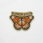 Flower Child monarch butterfly embroidered iron-on patch on clean white surface