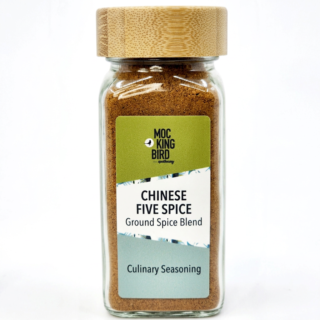 Illustrative Mockingbird Chinese Five Spice Powder jar with bamboo lid and green, white and pale sage-blue label.