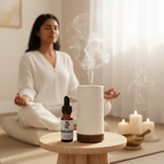 Meditation Essential Oil Blend – lifestyle with Joy Flower Diffuser, South Asian woman meditating in white linen with candles and singing bowl