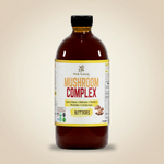 Herb To Body Mushroom Complex Bitters bottle on pale earthy tan background