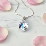 Crystal AB teardrop pendant close-up showing iridescent aurora borealis shimmer