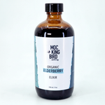 Mockingbird Apothecary Organic Elderberry Elixir on soft aqua background with natural shadow
