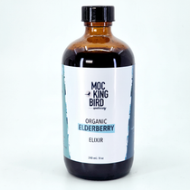 Mockingbird Apothecary Organic Elderberry Elixir on soft aqua background with natural shadow