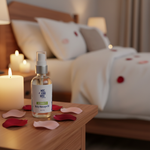 Romance Massage Oil lifestyle on bedside table with candles and rose petals, warm candlelit bedroom