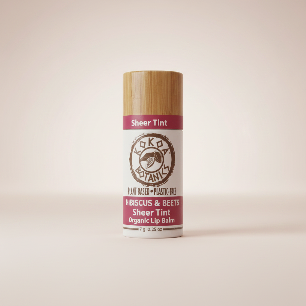 Kokoa Botanics Hibiscus & Beets Sheer Tint Organic Lip Balm on soft blush background