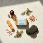 Palo Santo Goat Milk Bar Soap No.20 – lifestyle flat lay with palo santo wood, cedarwood, juniper and stones