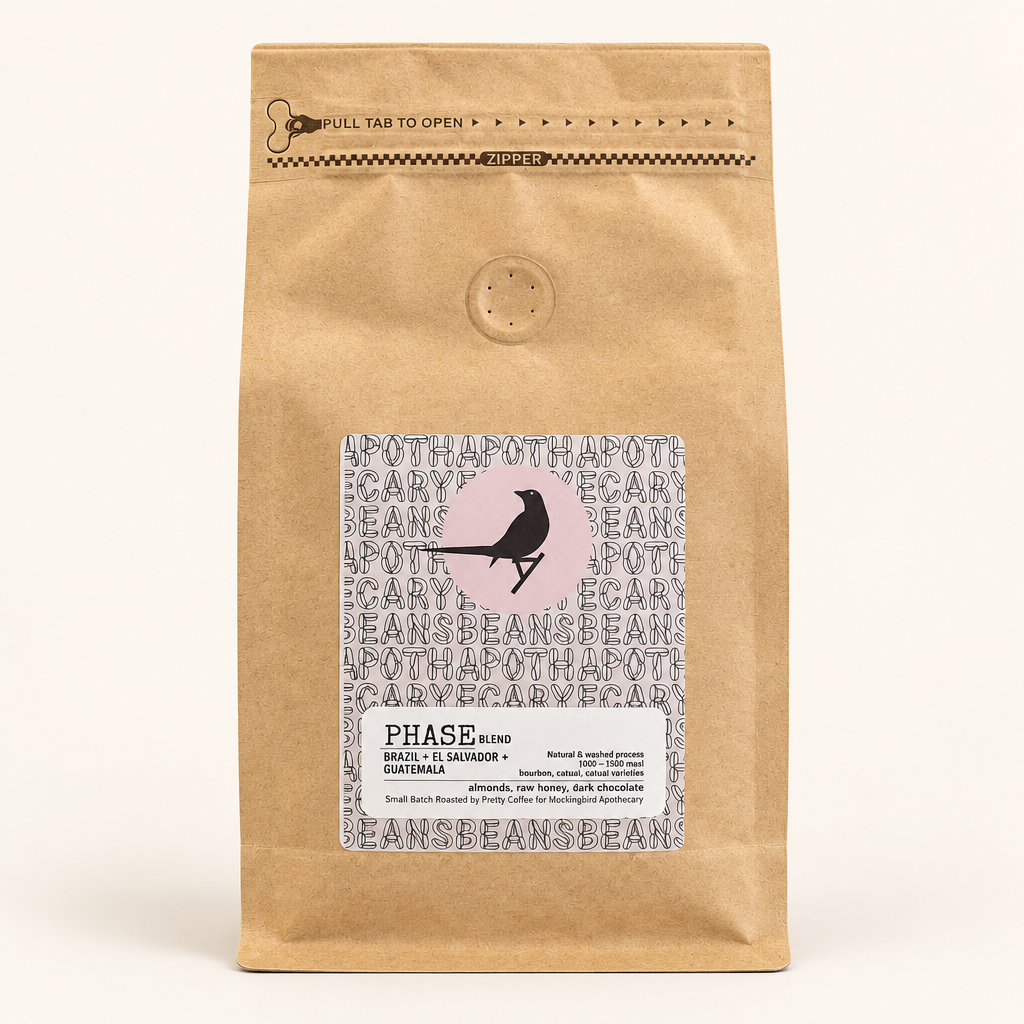Phase Blend coffee in a kraft pouch with bird label on a pale studio background