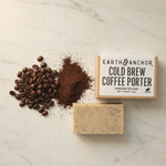 Cold Brew Coffee Porter soap lifestyle flat lay with roasted coffee beans and ground coffee on white marble