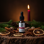 Christmas Morning Essential Oil Blend – eclectic editorial on rustic wood with cloves, star anise, fir, dried orange and candlelight