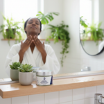 Daily Greens Superfood Cream lifestyle with Black woman applying cream to neck in botanical bathroom