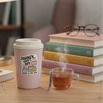 Books buy happiness vinyl sticker on a pastel travel mug with books, tea, and reading glasses
