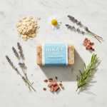 Colloidal Oatmeal & Calendula Goat Milk Bar Soap – lifestyle flat lay with oats, lavender, chamomile, rosemary and cedar