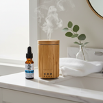 Deep Breath Essential Oil Blend – lifestyle with Bamboo Diffuser on morning bathroom vanity with eucalyptus and marble
