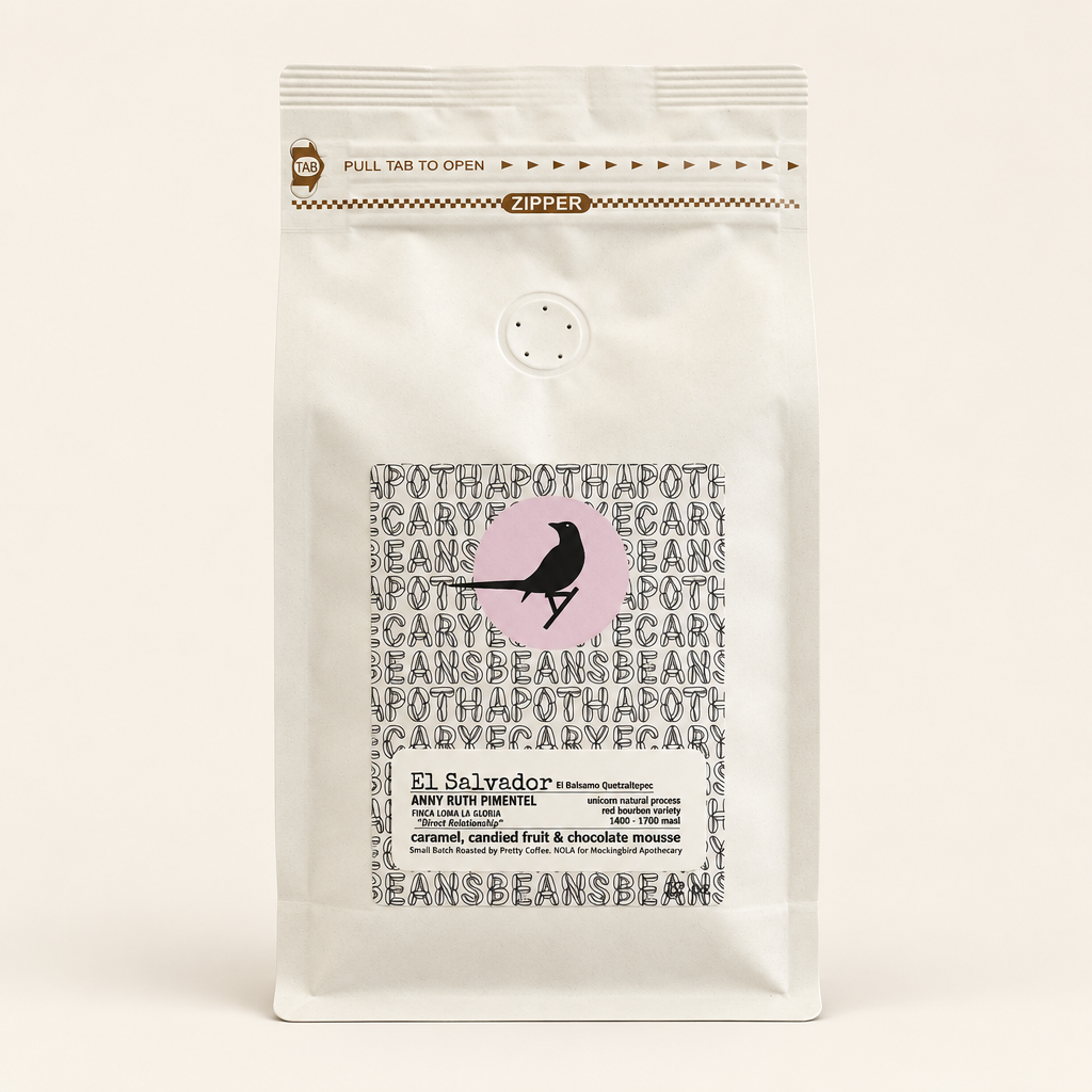 El Salvador Finca Loma La Gloria coffee in an ivory resealable bag on a warm off-white background