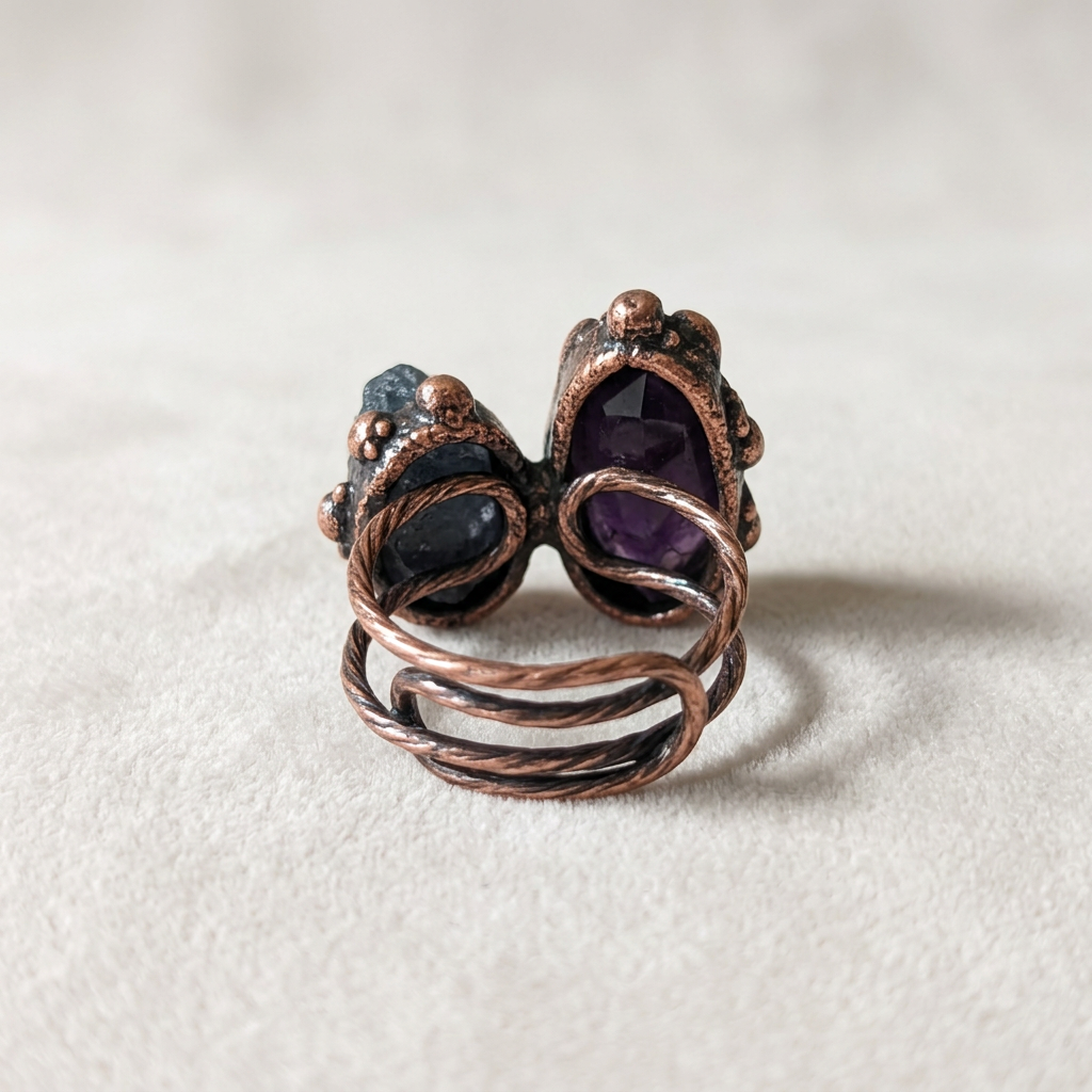 Back view of the amethyst and raw stone ring showing the wrapped copper wire band
