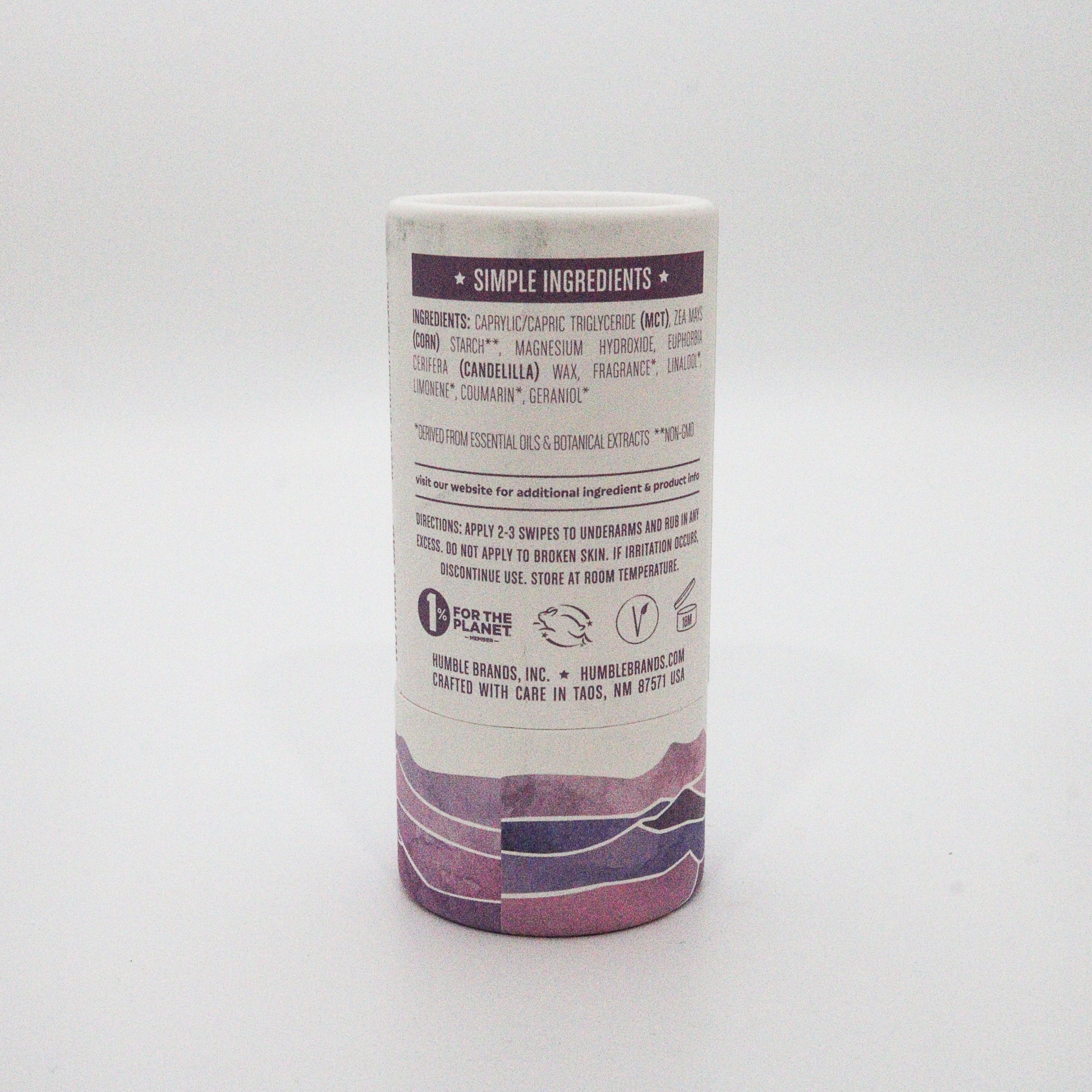 Cylindrical container with purple and white label on a light gray background